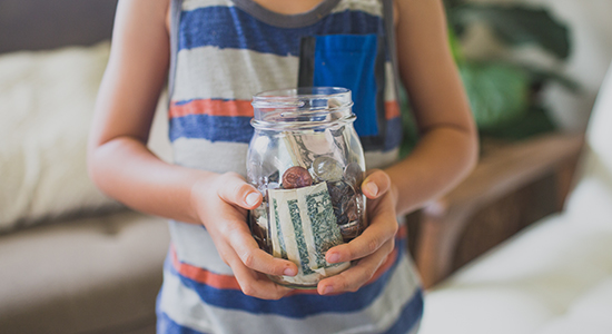 Child with money jar