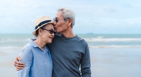 Couple in their 60s on beach together