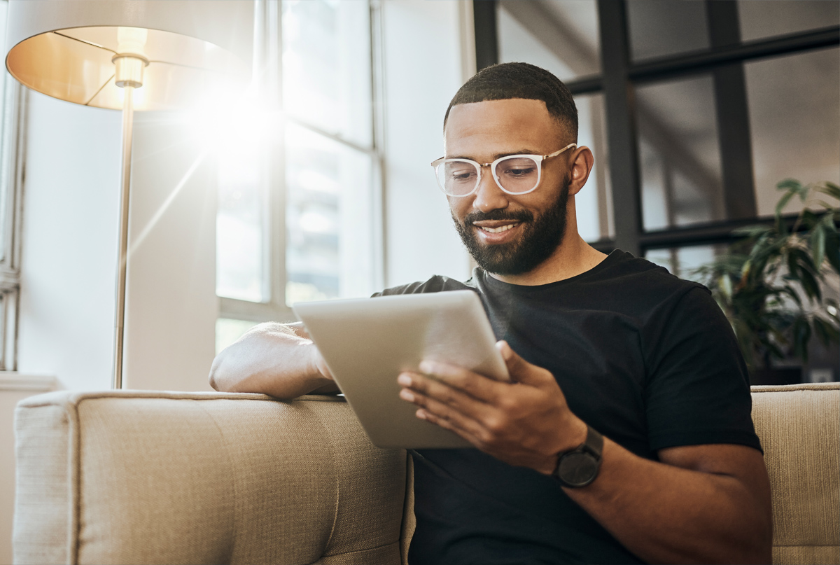 Smiling man looking at tablet