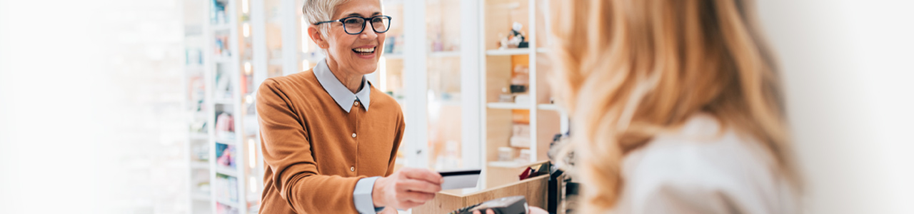 Woman using debit card at a convenience store